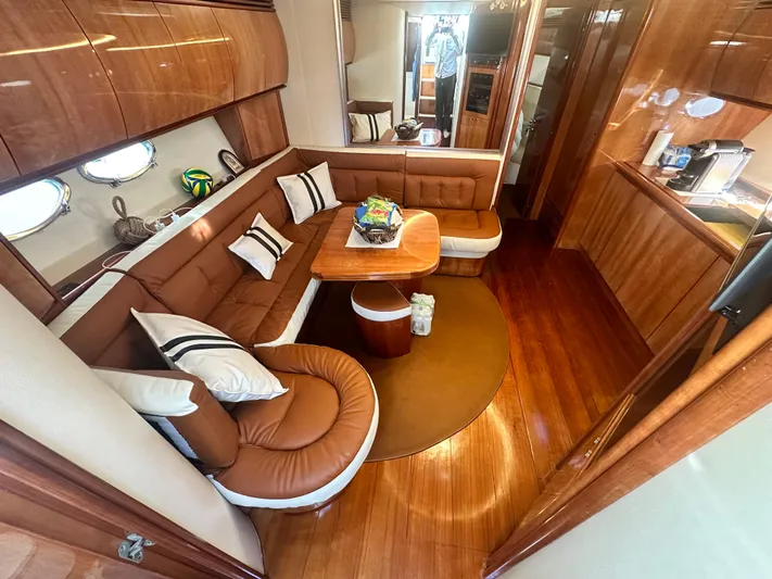  Yacht Photos Pics Luxurious interior of 2000 Pershing 54 yacht with elegant wood finish and plush seating.