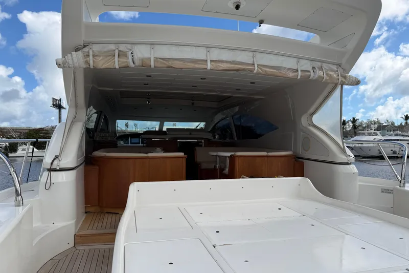  Yacht Photos Pics 2004 Mangusta 72 yacht with open deck and luxurious interior, docked at marina.