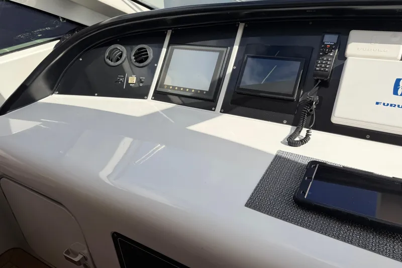  Yacht Photos Pics Control panel of a 2004 Mangusta 72 yacht with navigation screens and communication devices.