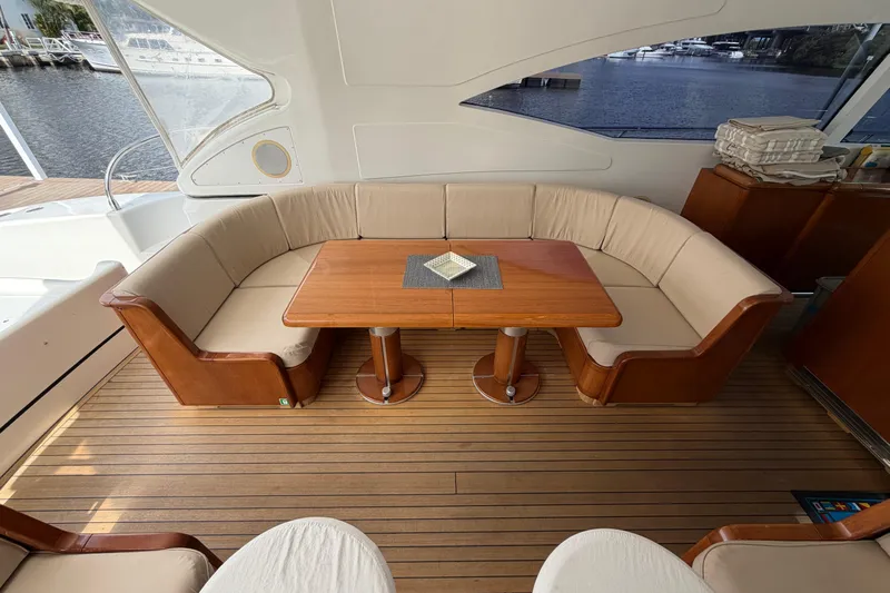  Yacht Photos Pics Luxurious 2004 Mangusta 72 yacht interior with elegant seating and wooden table.
