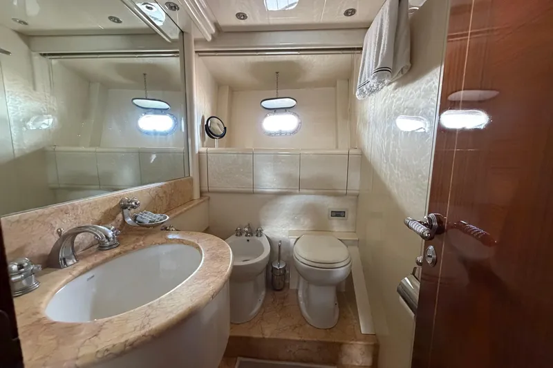  Yacht Photos Pics Luxurious bathroom in 2004 Mangusta 72 yacht with marble sink and modern fixtures.