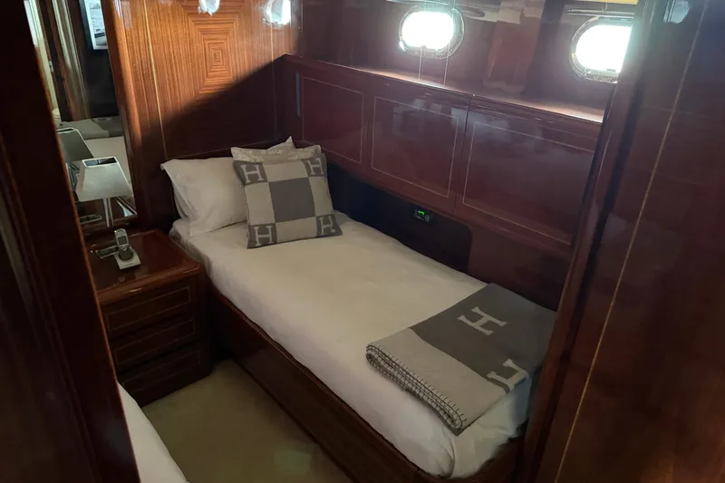  Yacht Photos Pics Luxurious cabin interior of 2004 Mangusta 72 yacht with elegant wood paneling.