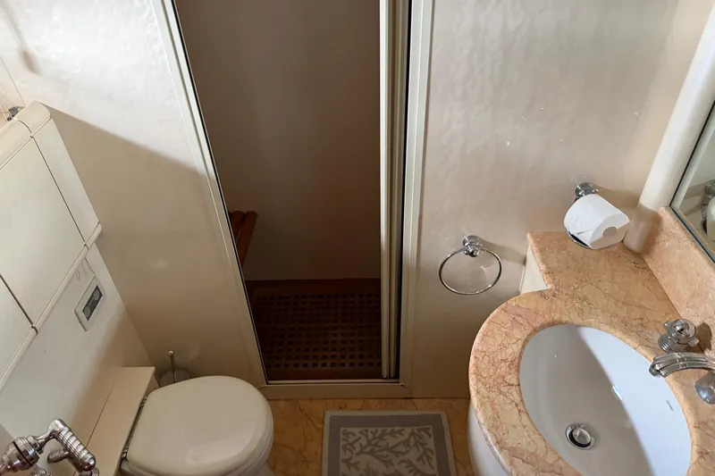  Yacht Photos Pics Luxurious bathroom in 2004 Mangusta 72 yacht with marble countertop and modern fixtures.