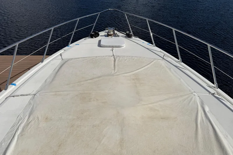  Yacht Photos Pics Bow view of 2004 Mangusta 72 yacht on calm water.