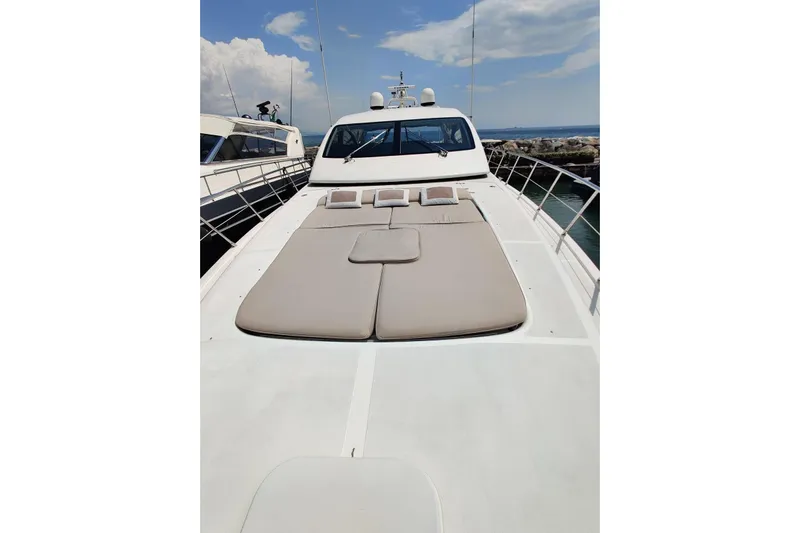  Yacht Photos Pics Luxurious 2004 Mangusta 72 yacht with spacious sunbathing deck and sleek design.