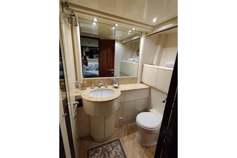  Yacht Photos Pics Luxurious bathroom in 2004 Mangusta 72 yacht with elegant fixtures and marble countertop.