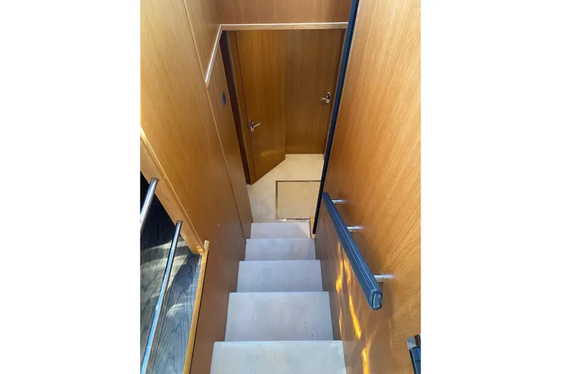Big Blue Yacht Photos Pics Staircase inside 2014 Fairline Squadron 78 Custom yacht with wooden paneling.