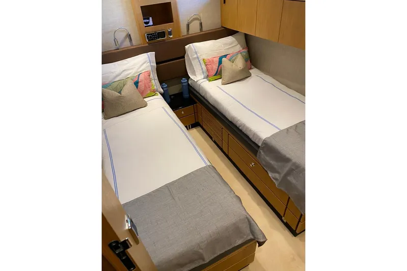 Big Blue Yacht Photos Pics Twin cabin interior of 2014 Fairline Squadron 78 Custom yacht, featuring modern design and cozy bedding.