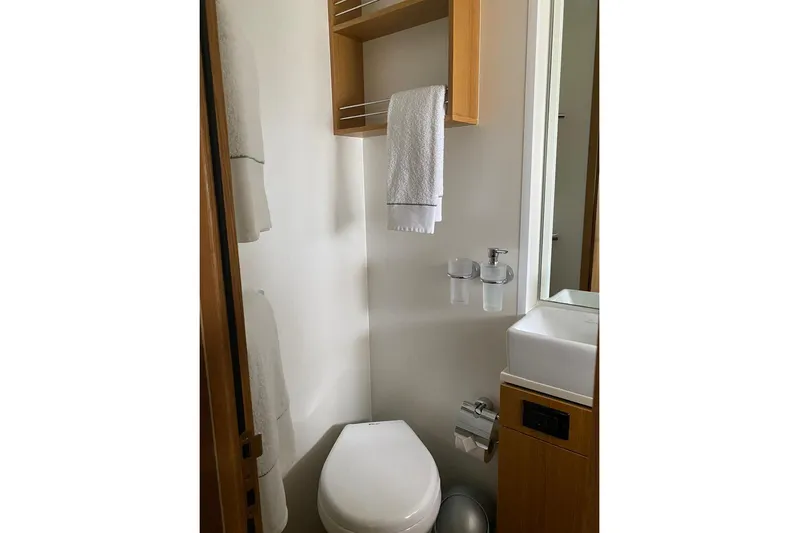 Big Blue Yacht Photos Pics Bathroom interior of 2014 Fairline Squadron 78 Custom yacht, featuring modern fixtures and wooden accents.