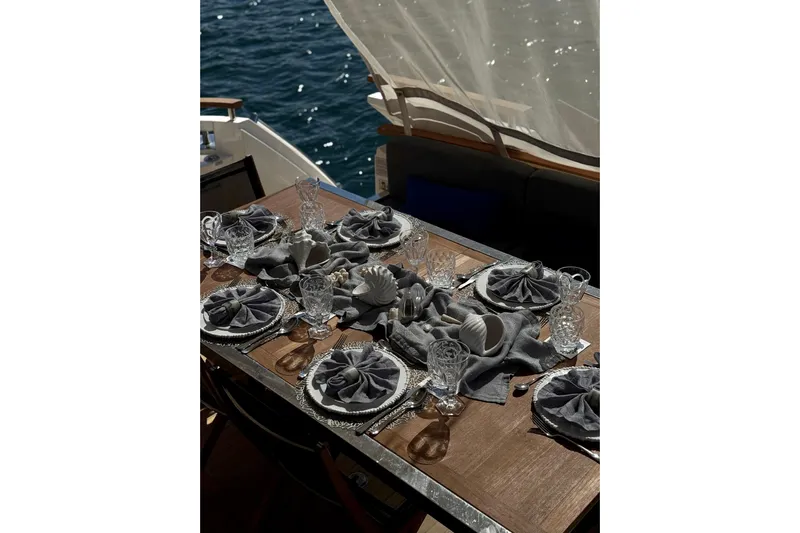 Big Blue Yacht Photos Pics Elegant dining setup on 2014 Fairline Squadron 78 Custom yacht, overlooking the ocean.