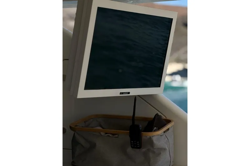 Big Blue Yacht Photos Pics 2014 Fairline Squadron 78 Custom yacht interior with mounted screen and storage basket.