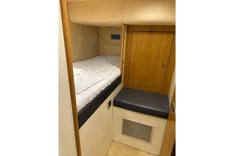 Big Blue Yacht Photos Pics 2014 Fairline Squadron 78 Custom yacht cabin with bed and wooden storage.