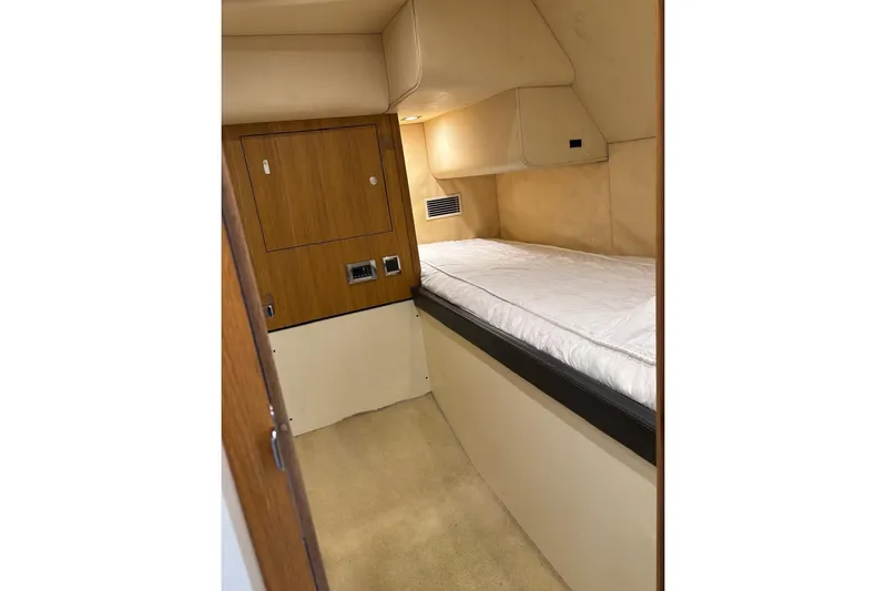 Big Blue Yacht Photos Pics 2014 Fairline Squadron 78 Custom yacht cabin with single bed and wooden cabinetry.