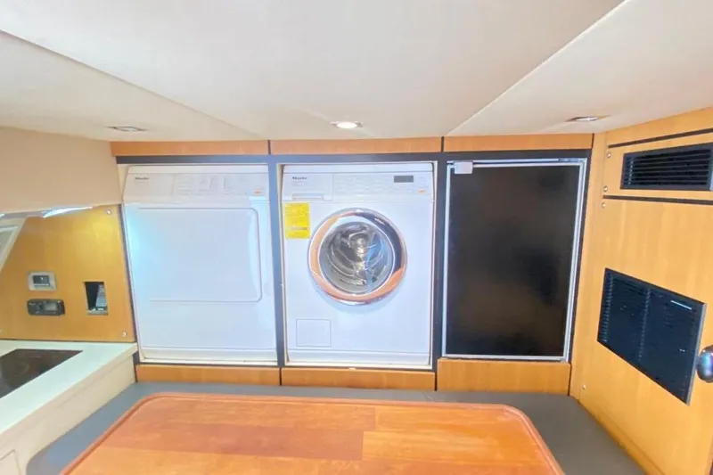 Big Blue Yacht Photos Pics Laundry area in 2014 Fairline Squadron 78 Custom yacht with washer and dryer.