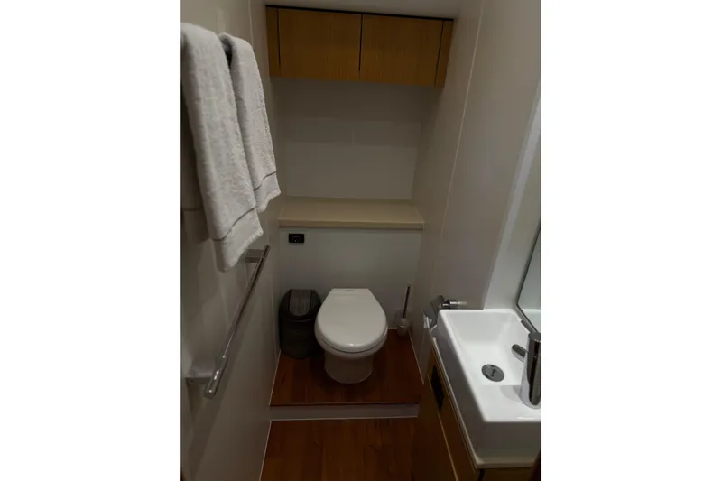 Big Blue Yacht Photos Pics Bathroom interior of 2014 Fairline Squadron 78 Custom yacht, featuring modern fixtures and wooden accents.