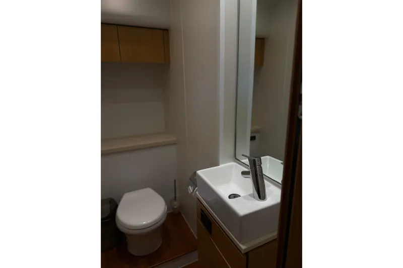 Big Blue Yacht Photos Pics Bathroom interior of 2014 Fairline Squadron 78 Custom yacht, featuring modern sink and toilet.