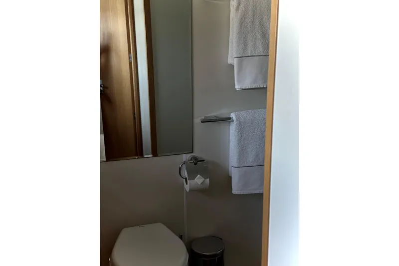 Big Blue Yacht Photos Pics Bathroom interior of 2014 Fairline Squadron 78 Custom yacht, featuring towels and modern fixtures.