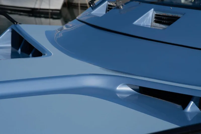 Azaxaki Yacht Photos Pics Close-up of a 1995 Magnum 50 Bestia yacht's sleek blue deck design.