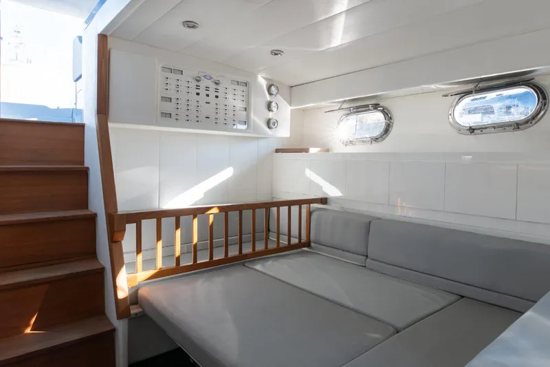 Azaxaki Yacht Photos Pics Interior of 1995 Magnum 50 Bestia yacht with modern seating and wooden accents.