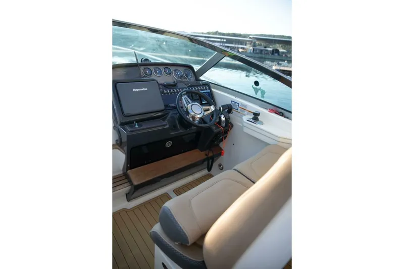  Yacht Photos Pics Helm of 2016 Sea Ray 350 Sundancer with steering wheel and navigation equipment.