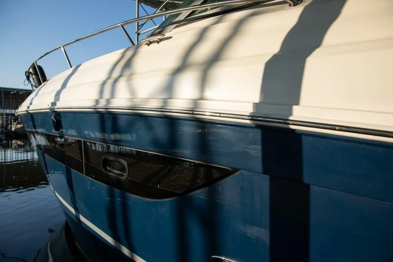  Yacht Photos Pics 2016 Sea Ray 350 Sundancer boat side view with blue and white hull.