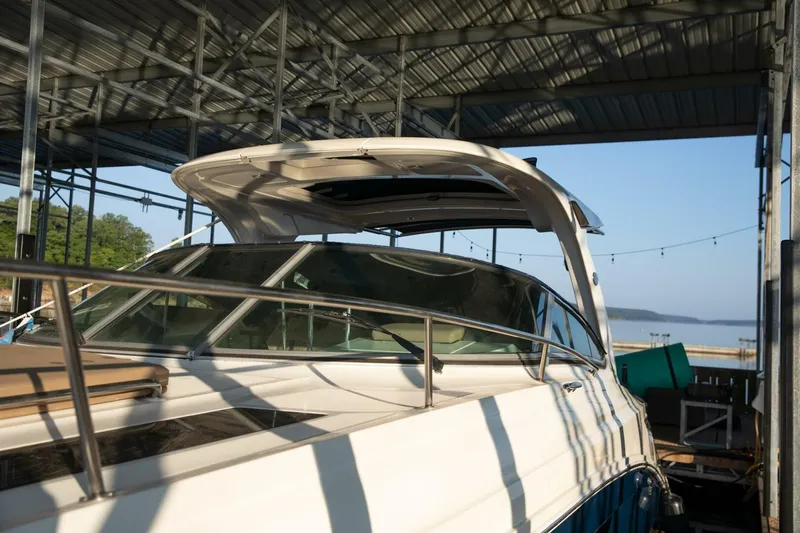  Yacht Photos Pics 2016 Sea Ray 350 Sundancer docked under a metal canopy with scenic lake view.