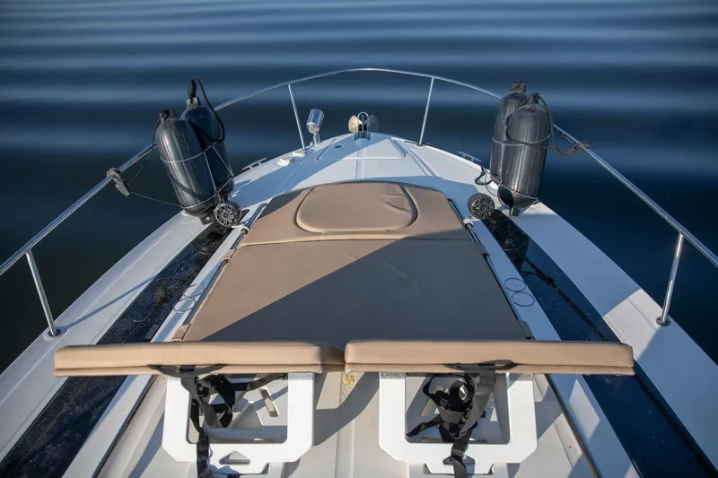  Yacht Photos Pics 2016 Sea Ray 350 Sundancer boat deck with sunbed and calm water view.