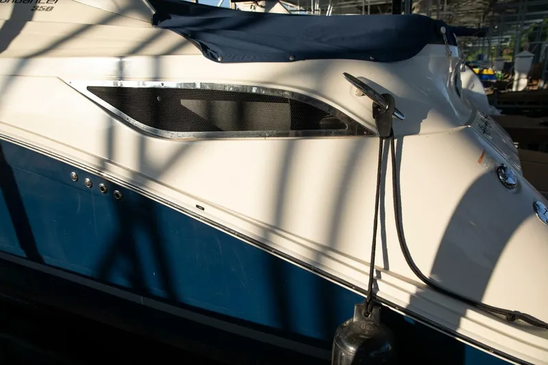  Yacht Photos Pics 2016 Sea Ray 350 Sundancer boat side view with shadows and docked rope.
