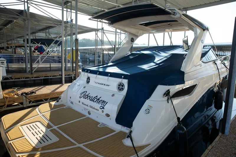  Yacht Photos Pics 2016 Sea Ray 350 Sundancer docked, covered with blue tarp, in marina setting.