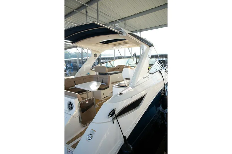  Yacht Photos Pics 2016 Sea Ray 350 Sundancer yacht with spacious deck and seating under a covered marina.