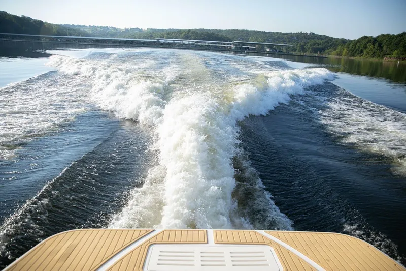  Yacht Photos Pics Wake behind a 2016 Sea Ray 350 Sundancer on a serene lake.