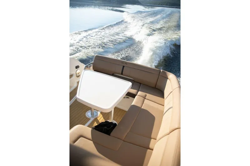  Yacht Photos Pics 2016 Sea Ray 350 Sundancer boat with beige seating and table, cruising on water.