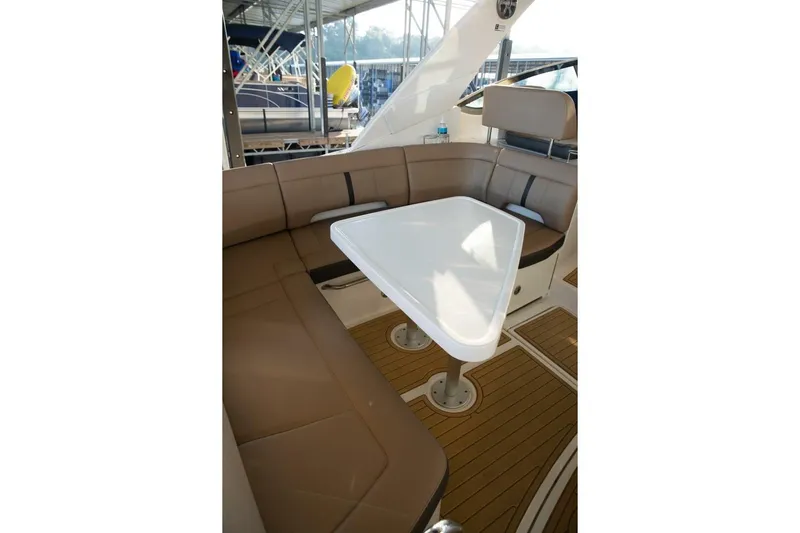  Yacht Photos Pics Interior seating area of 2016 Sea Ray 350 Sundancer with brown cushions and white table.