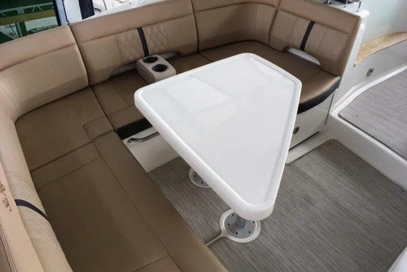  Yacht Photos Pics Luxurious seating area on a 2016 Sea Ray 350 Sundancer yacht with a triangular table.
