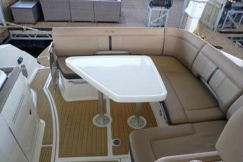  Yacht Photos Pics 2016 Sea Ray 350 Sundancer interior with beige seating and white table.