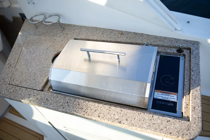 Yacht Photos Pics Built-in grill on 2016 Sea Ray 350 Sundancer boat, featuring Kenyon cooking appliance.