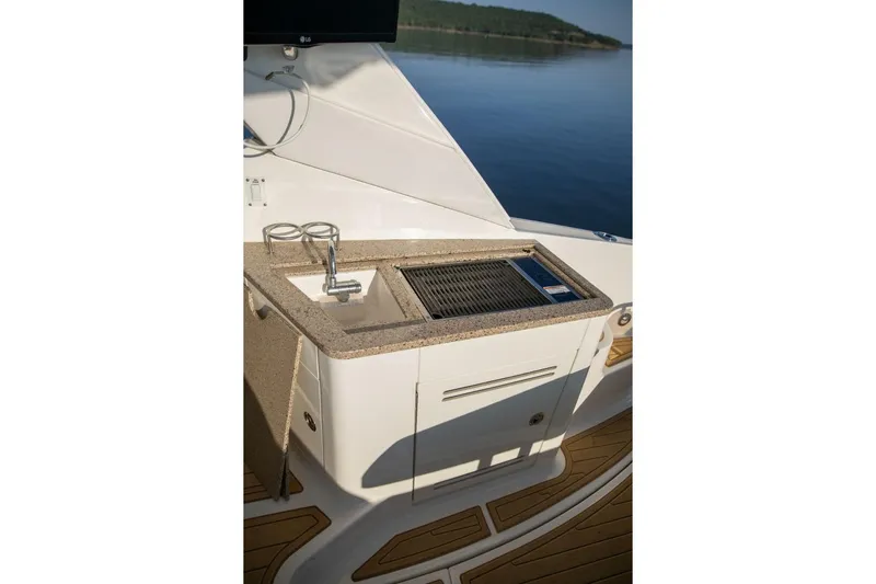  Yacht Photos Pics Outdoor kitchenette on 2016 Sea Ray 350 Sundancer yacht with sink and grill.