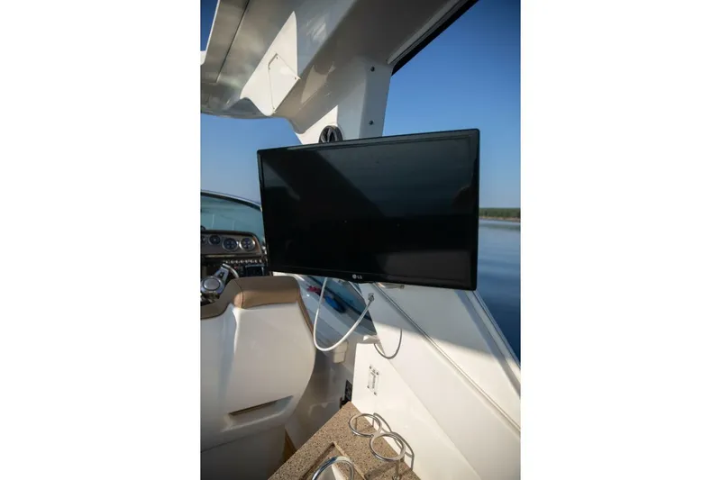  Yacht Photos Pics 2016 Sea Ray 350 Sundancer helm with mounted screen and cup holders.