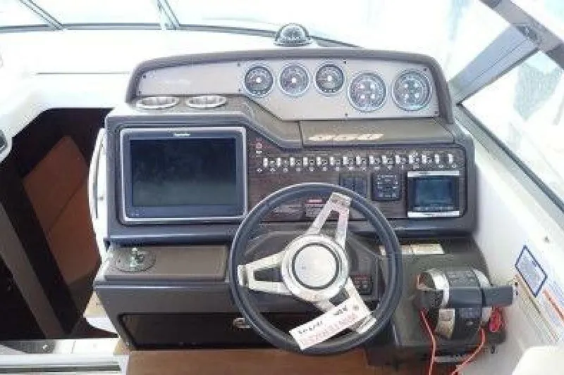  Yacht Photos Pics Cockpit of 2016 Sea Ray 350 Sundancer with steering wheel and navigation controls.