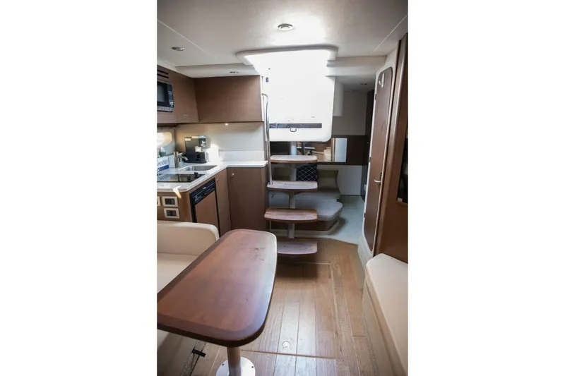  Yacht Photos Pics Interior of 2016 Sea Ray 350 Sundancer yacht with modern kitchen and wooden stairs.