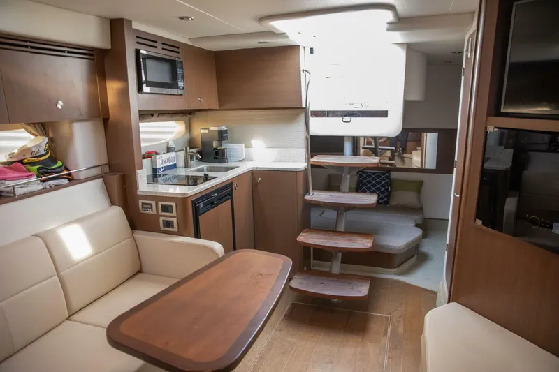  Yacht Photos Pics Interior of 2016 Sea Ray 350 Sundancer yacht with modern kitchen and seating area.