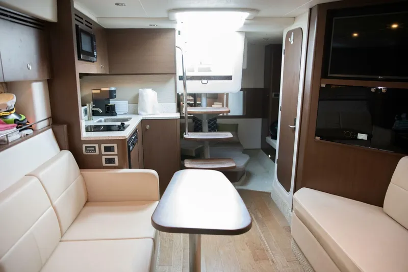  Yacht Photos Pics 2016 Sea Ray 350 Sundancer interior with modern kitchen, seating, and entertainment area.