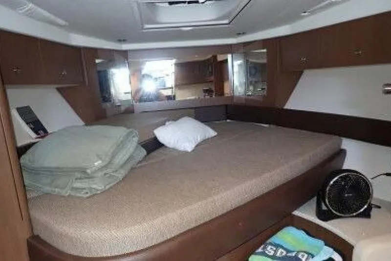  Yacht Photos Pics Interior cabin of 2016 Sea Ray 350 Sundancer with bed and storage cabinets.