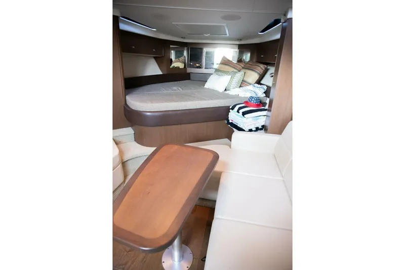  Yacht Photos Pics Interior of 2016 Sea Ray 350 Sundancer with cozy bed and seating area.