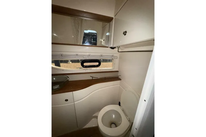  Yacht Photos Pics 2016 Sea Ray 350 Sundancer bathroom interior with toilet and wooden countertop.