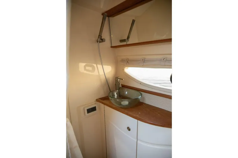  Yacht Photos Pics 2016 Sea Ray 350 Sundancer bathroom with glass sink and wooden countertop.