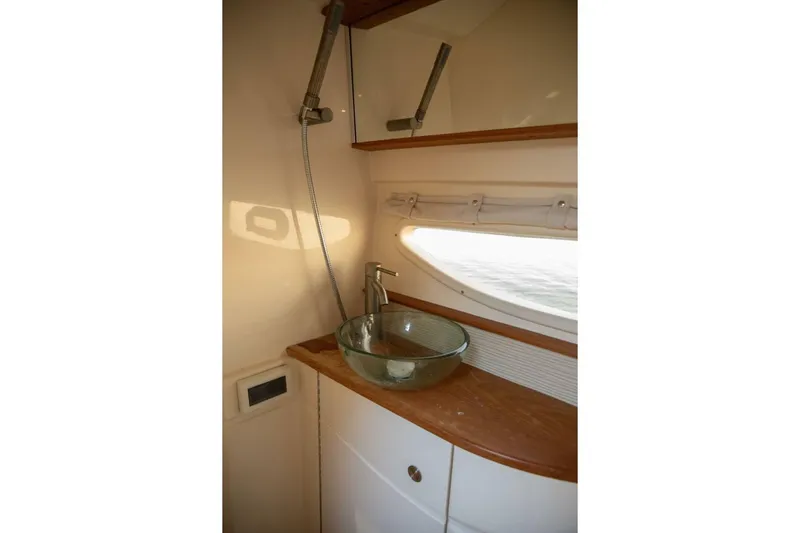  Yacht Photos Pics 2016 Sea Ray 350 Sundancer bathroom with glass sink and wooden countertop.