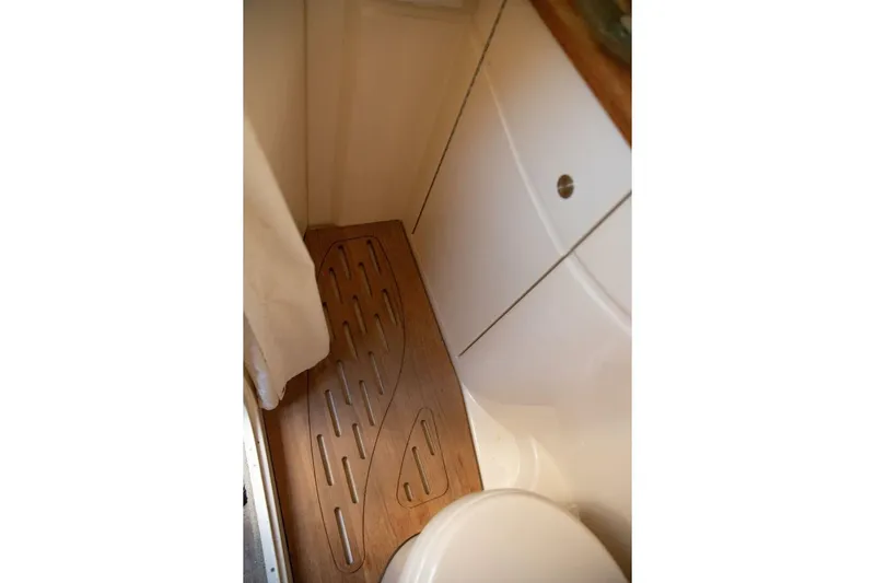  Yacht Photos Pics Bathroom interior of 2016 Sea Ray 350 Sundancer with wooden floor mat.