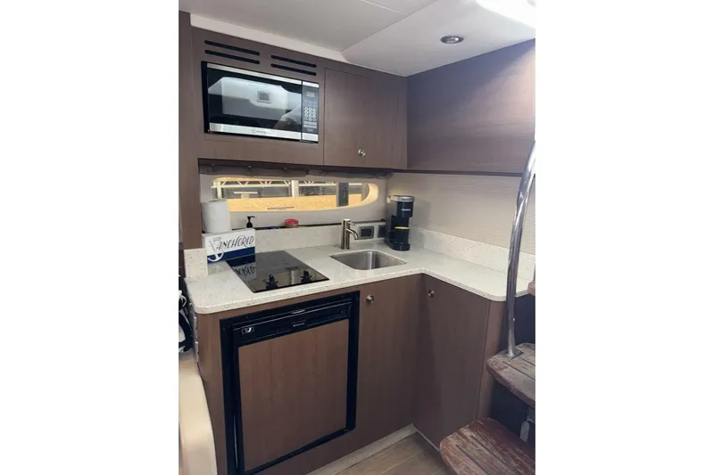  Yacht Photos Pics 2016 Sea Ray 350 Sundancer yacht kitchen with microwave, sink, and compact appliances.