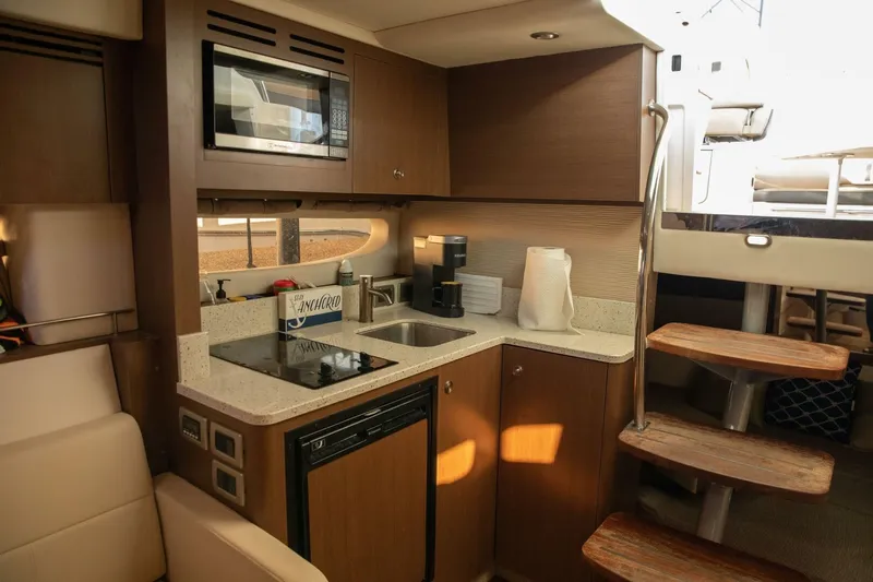  Yacht Photos Pics Interior of 2016 Sea Ray 350 Sundancer yacht kitchen with modern amenities.